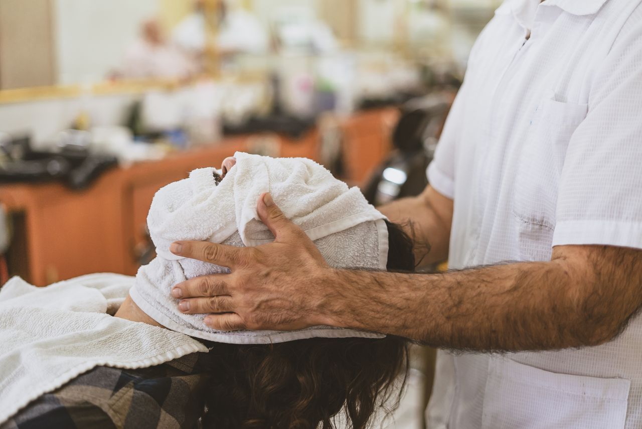Hot towel grooming treatment in barber chair